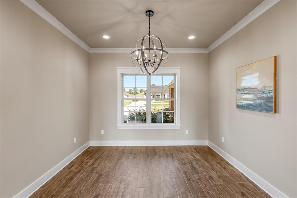 125 Sitka Loop Haughton, LA 71037 - Photo 7 of 29 a view of an empty room with wooden floor and a window