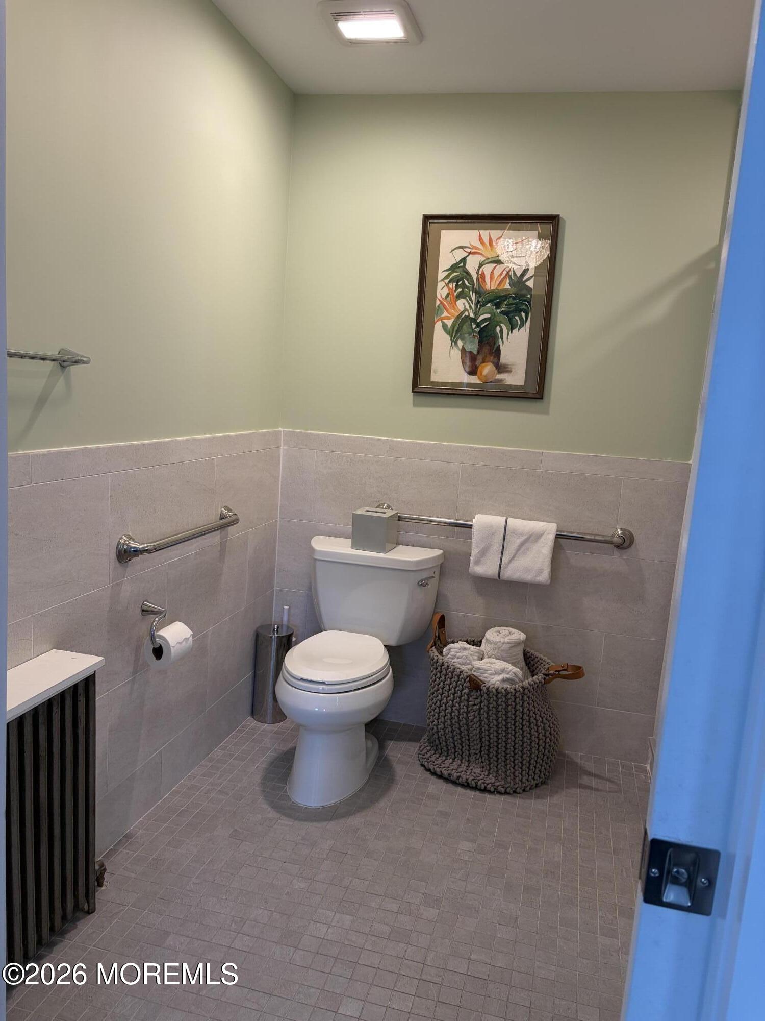 67 E Street Seaside Park, NJ 08752 - Photo 13 of 26 a white toilet sitting next to a bathroom sink