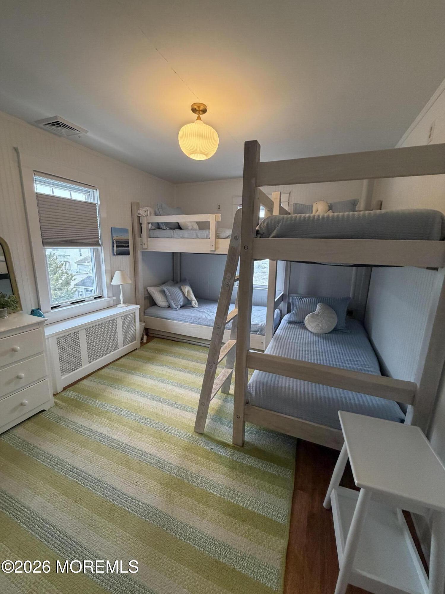 67 E Street Seaside Park, NJ 08752 - Photo 17 of 26 a bedroom with a bed and window