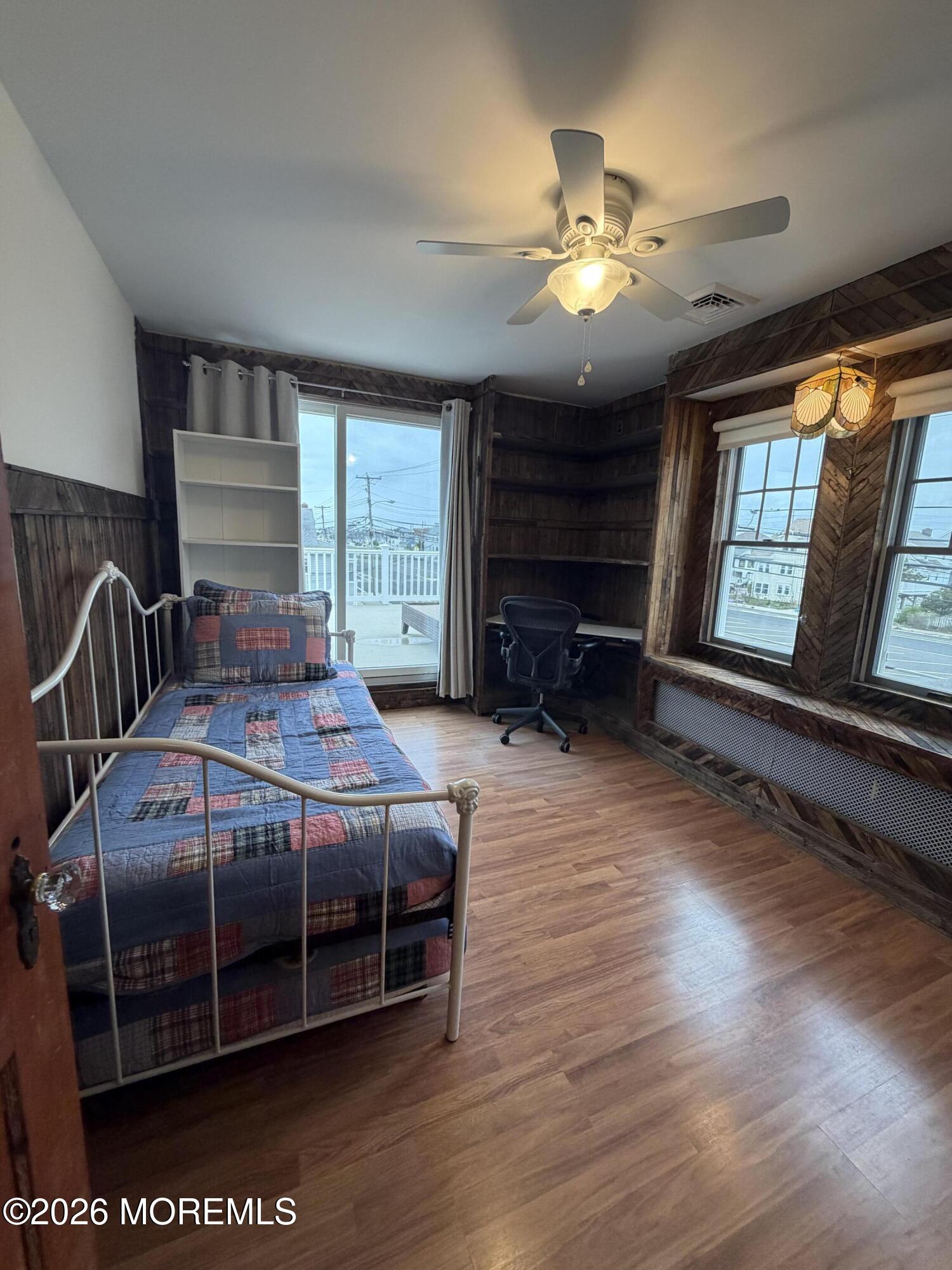67 E Street Seaside Park, NJ 08752 - Photo 18 of 26 a bedroom with a bed and a chandelier