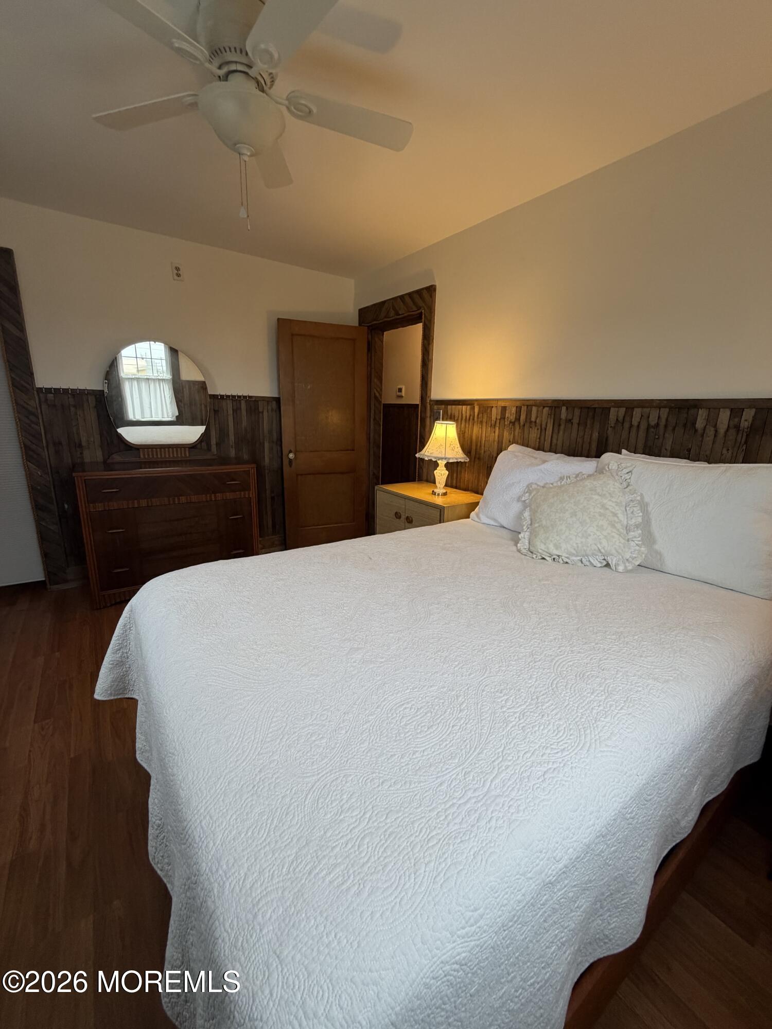 67 E Street Seaside Park, NJ 08752 - Photo 20 of 26 a bedroom with a bed and wooden floor