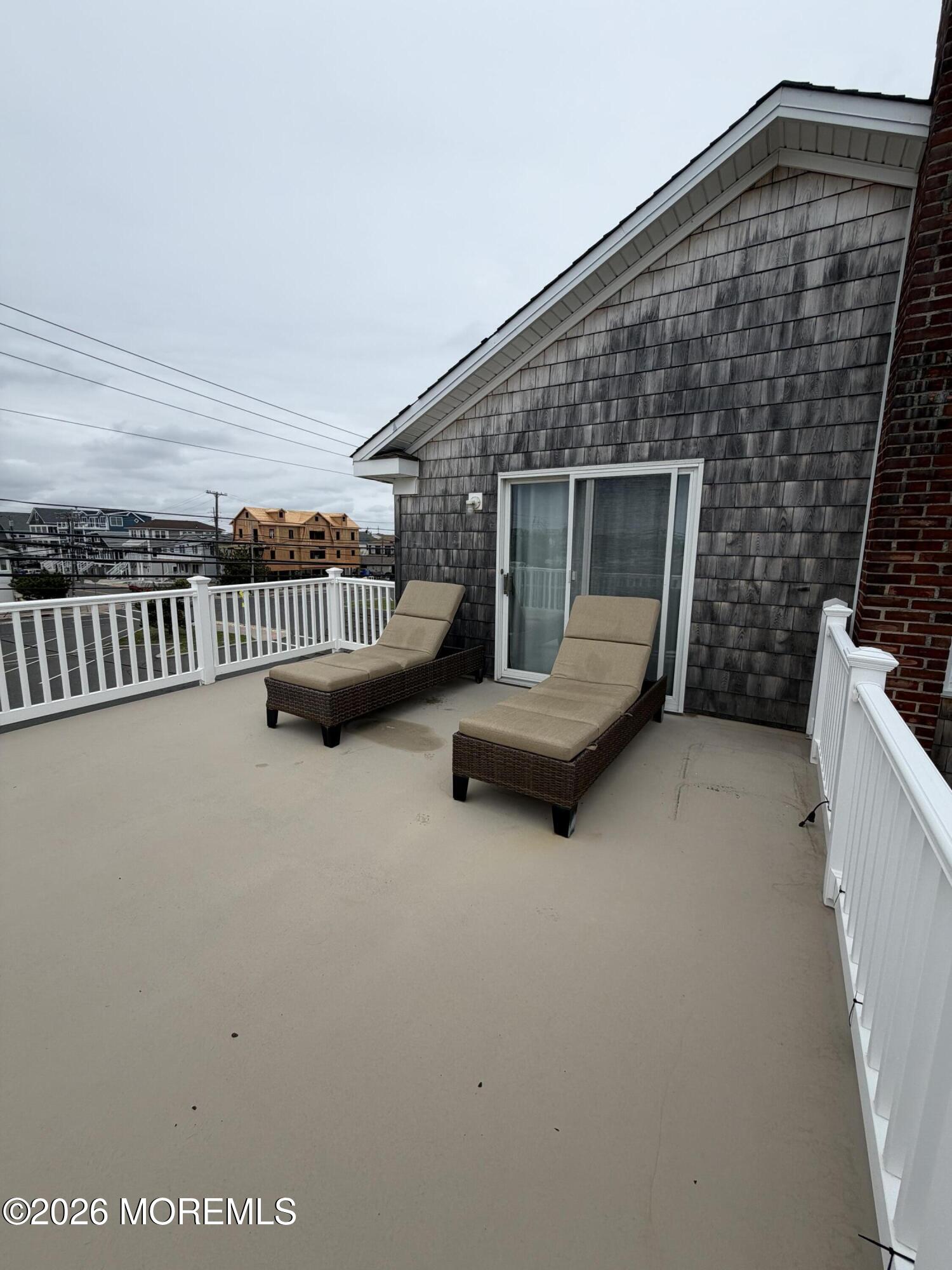 67 E Street Seaside Park, NJ 08752 - Photo 21 of 26 a view of a patio with couches and a fireplace