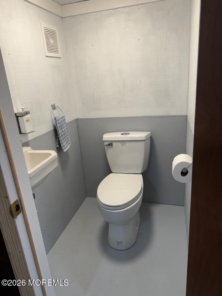 67 E Street Seaside Park, NJ 08752 - Photo 23 of 26 a white toilet sitting next to a sink