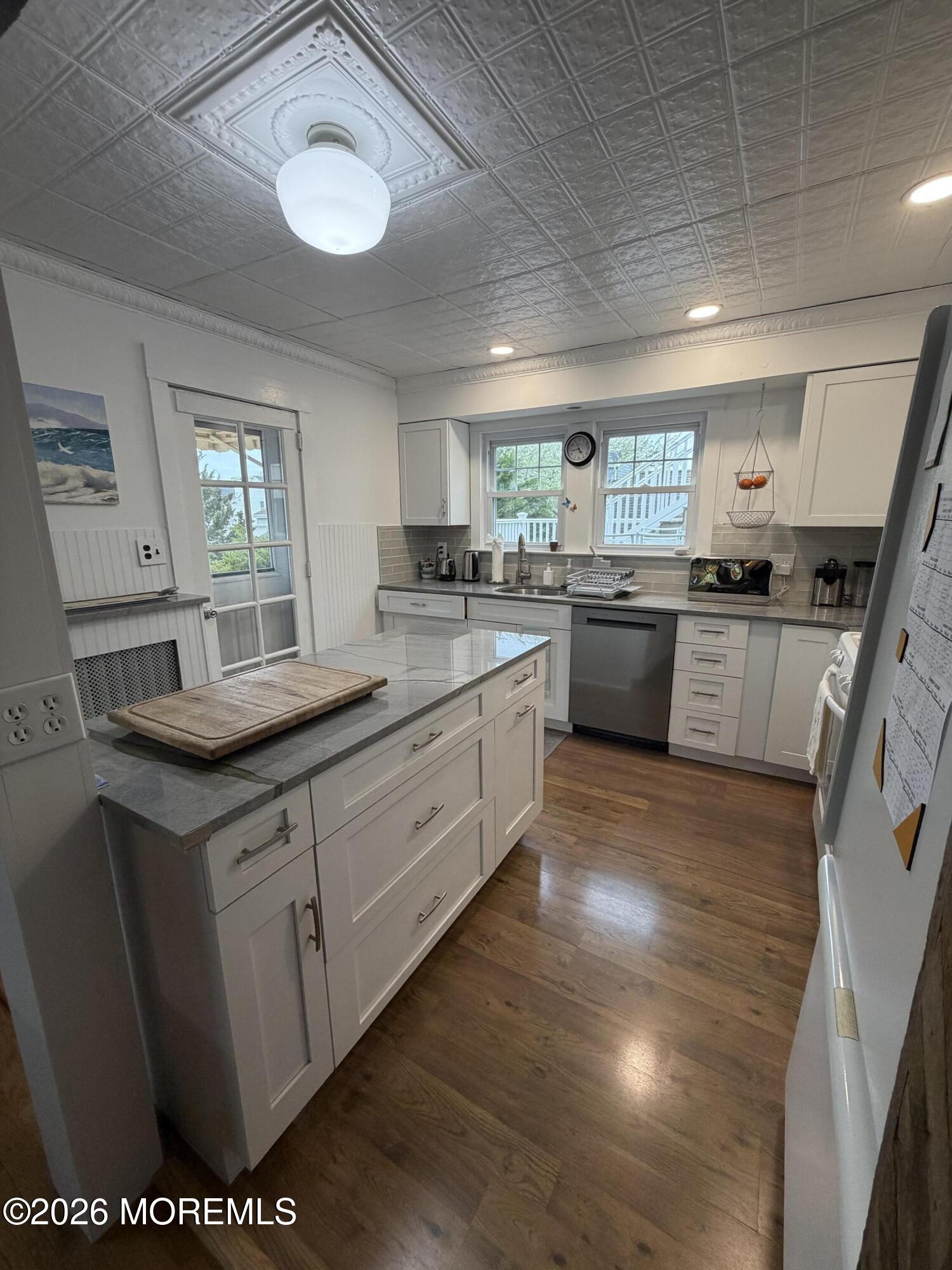 67 E Street Seaside Park, NJ 08752 - Photo 4 of 26 a kitchen with stainless steel appliances granite countertop a sink stove and cabinets