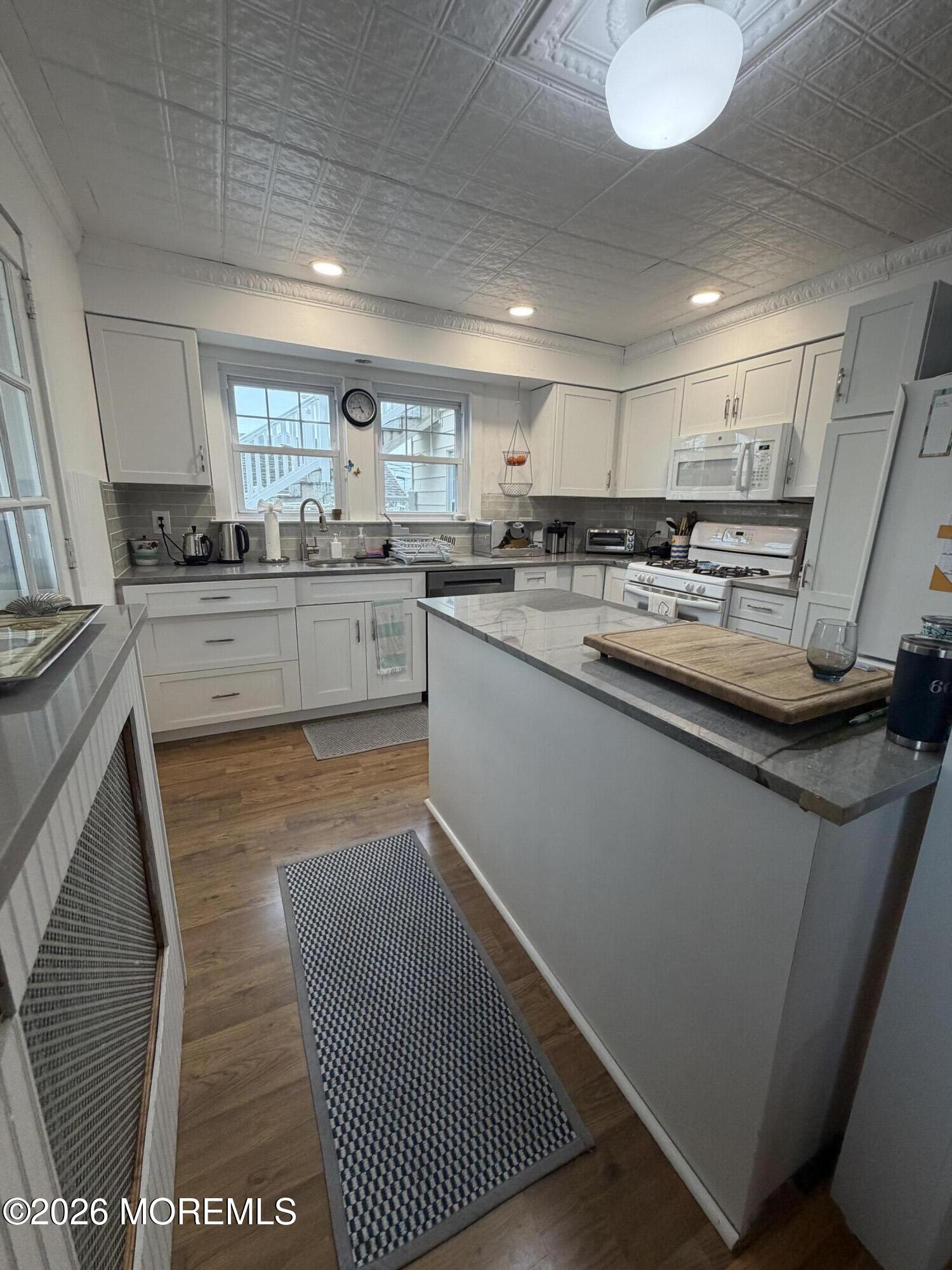 67 E Street Seaside Park, NJ 08752 - Photo 5 of 26 a kitchen with stainless steel appliances granite countertop a sink and cabinets