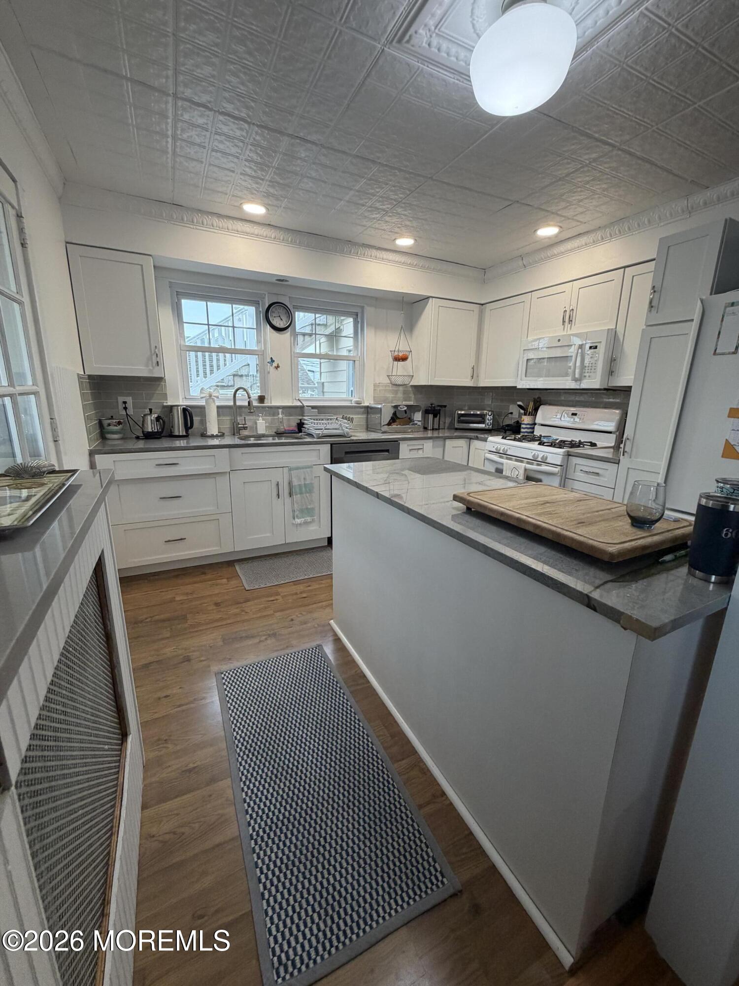 67 E Street Seaside Park, NJ 08752 - Photo 6 of 26 a kitchen with stainless steel appliances granite countertop a sink and cabinets