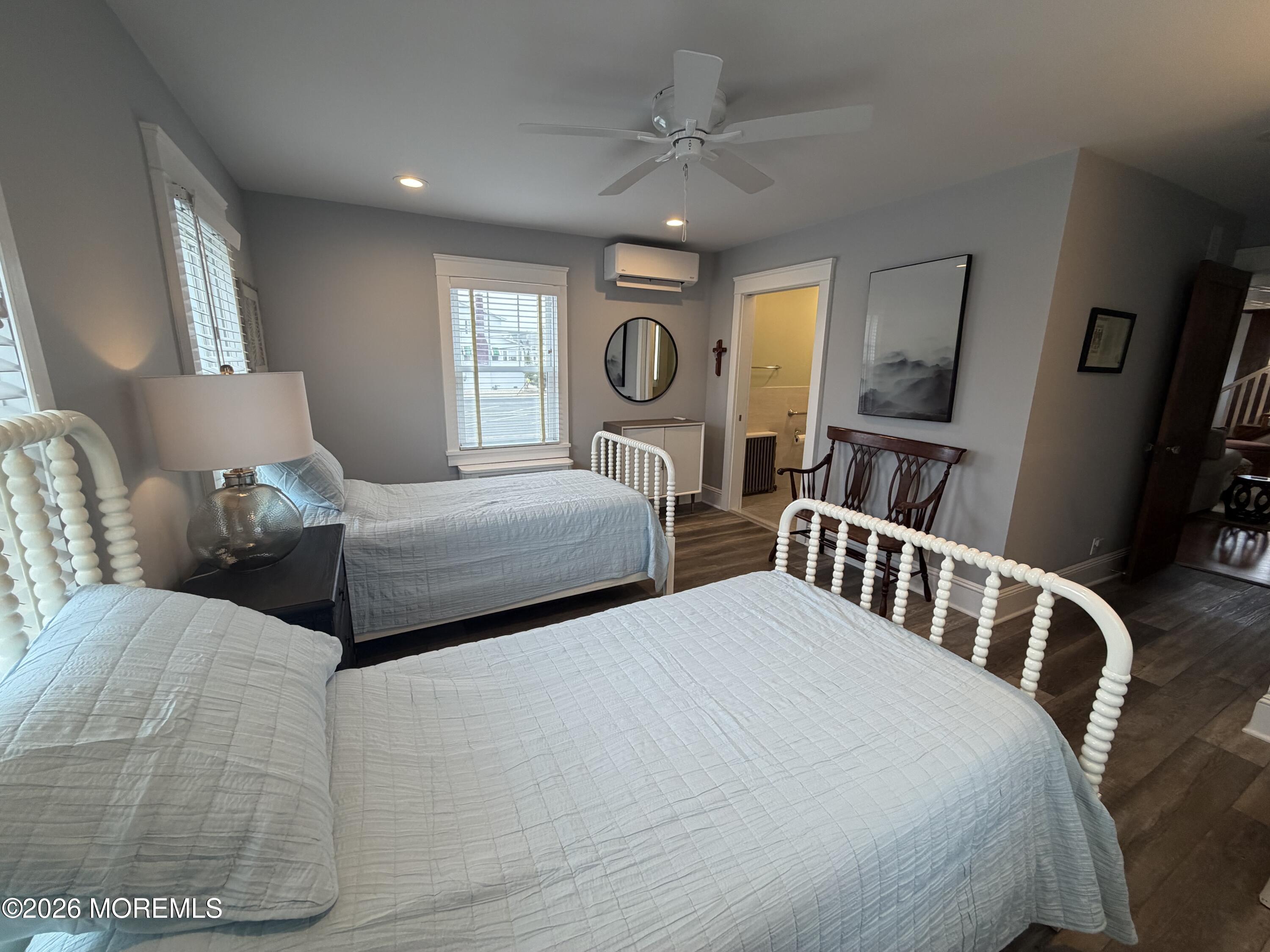 67 E Street Seaside Park, NJ 08752 - Photo 10 of 26 a bedroom with two beds and a chandelier