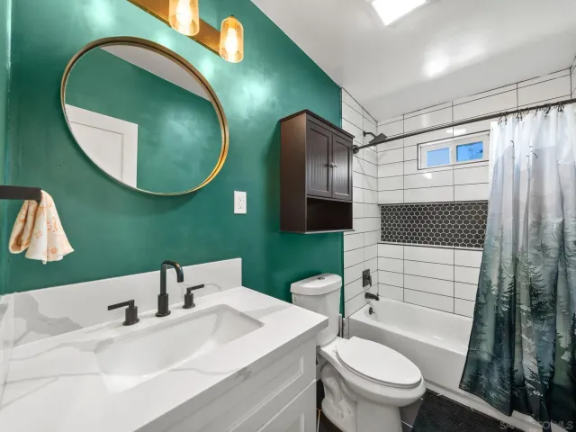 a bathroom with a sink a toilet and a mirror