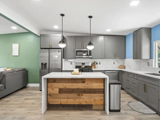 a kitchen with kitchen island a sink stove and wooden floor