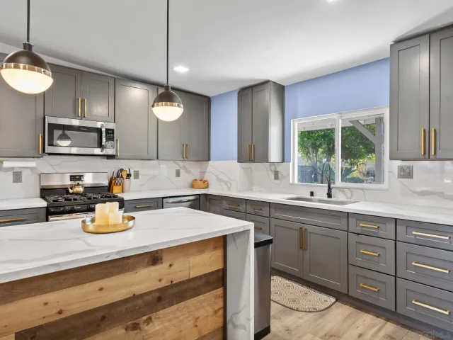 a kitchen with a sink a window and appliances