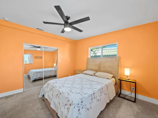 a bedroom with a large bed and a chandelier
