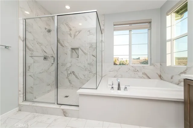 a bathroom with a tub sink and shower
