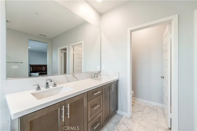 a bathroom with a sink double vanity and a mirror