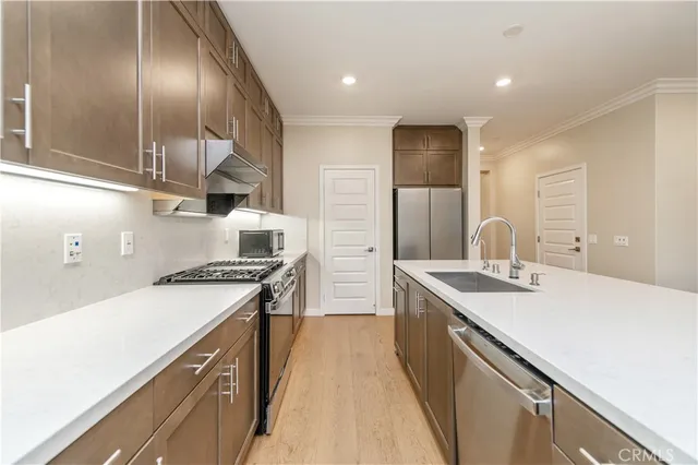 a kitchen with a sink stove and cabinets