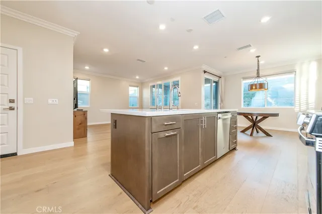 an open kitchen with a refrigerator and microwave