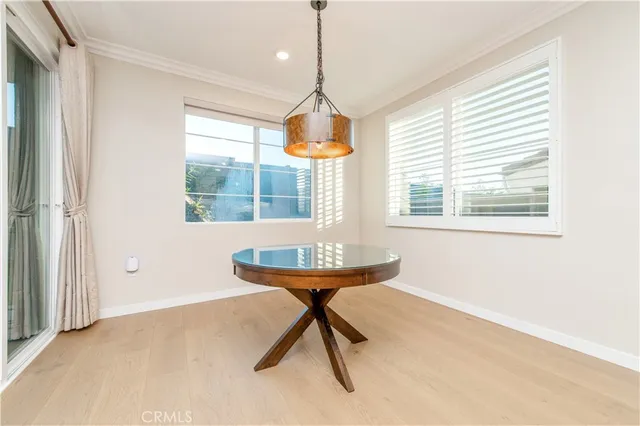 a dining room with chandelier and windows