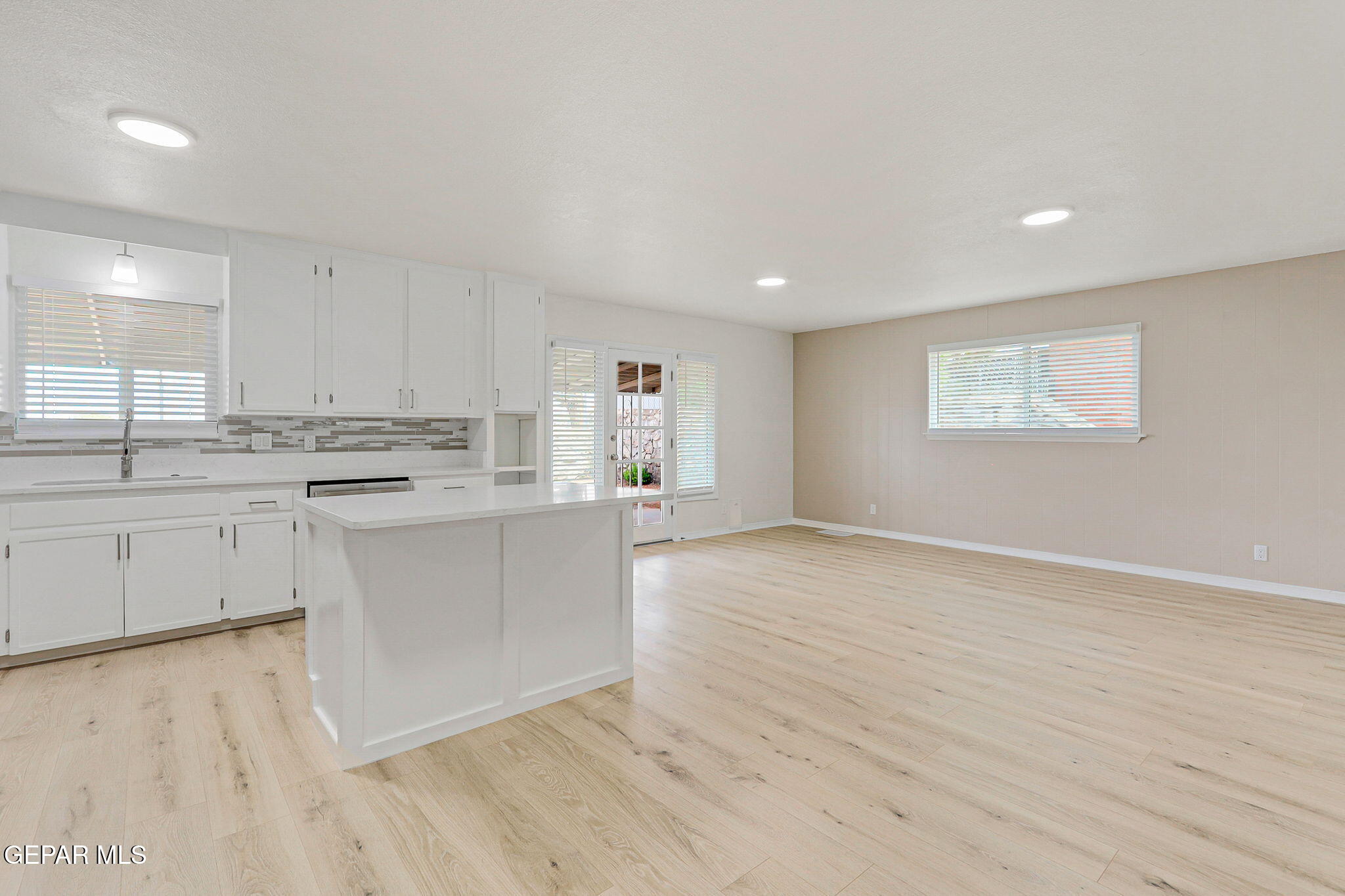 309 Clairemont Road El Paso, TX 79912 - Photo 14 of 40 a kitchen with stainless steel appliances white cabinets and wooden floor