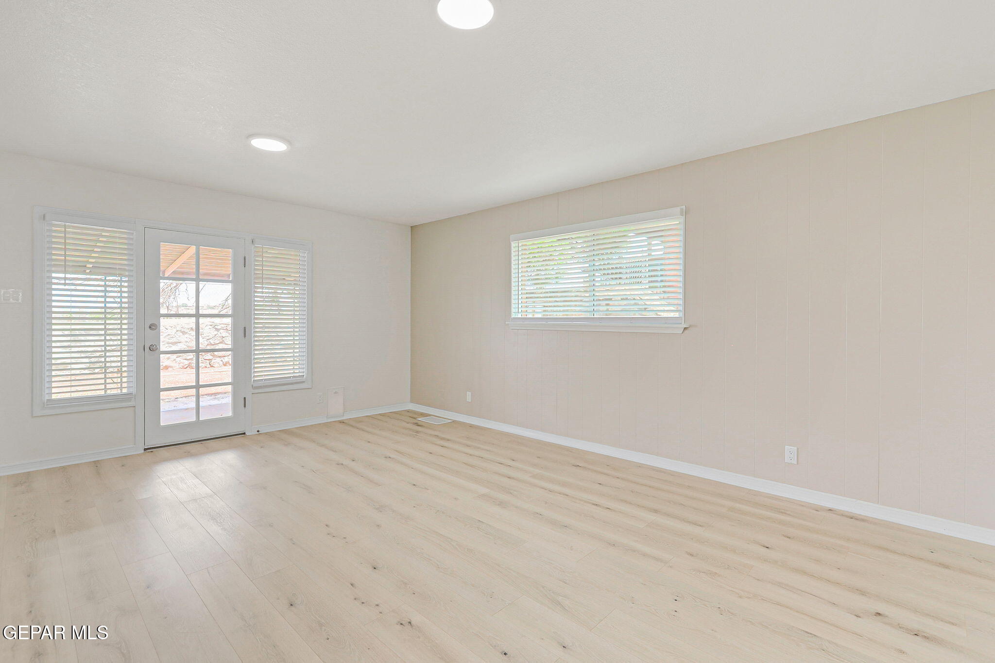 309 Clairemont Road El Paso, TX 79912 - Photo 17 of 40 an empty room with wooden floor and windows