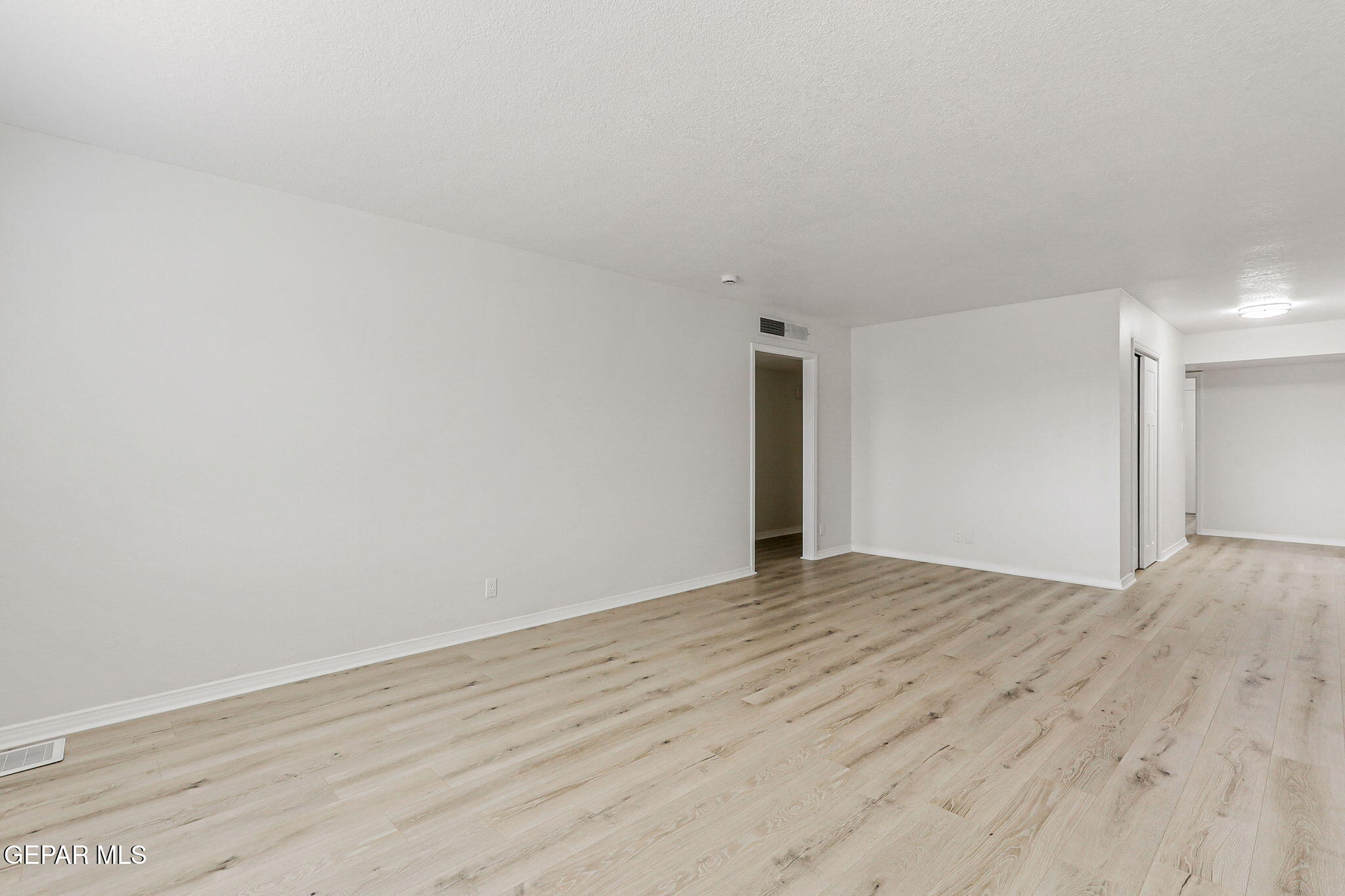 309 Clairemont Road El Paso, TX 79912 - Photo 19 of 40 a view of an empty room and wooden floor