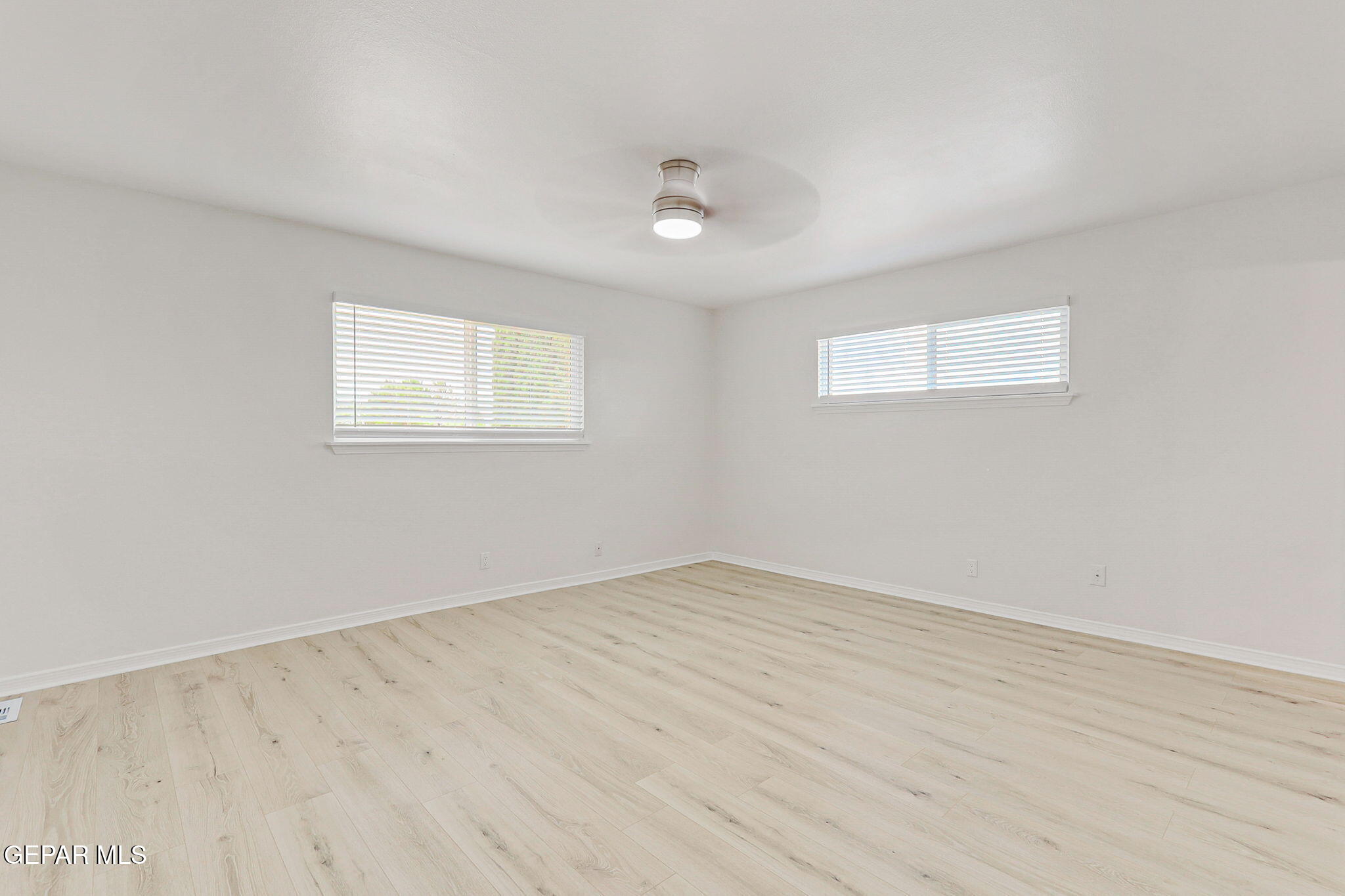 309 Clairemont Road El Paso, TX 79912 - Photo 22 of 40 an empty room with wooden floor and windows