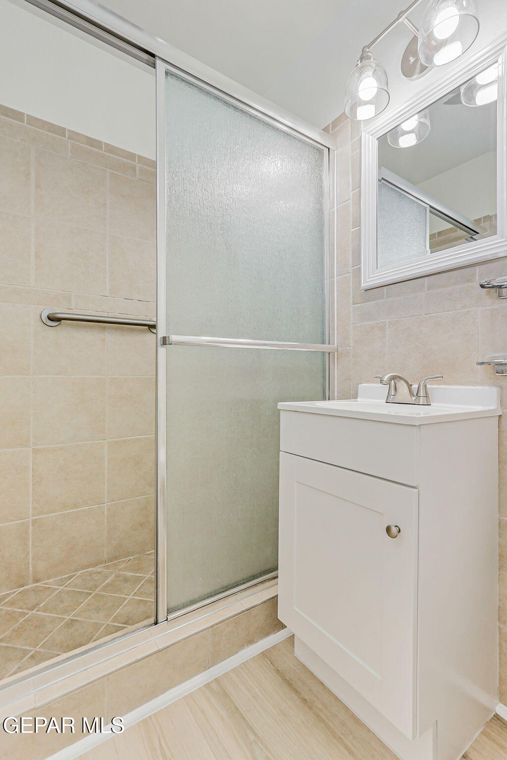 309 Clairemont Road El Paso, TX 79912 - Photo 25 of 40 a bathroom with a shower sink and mirror