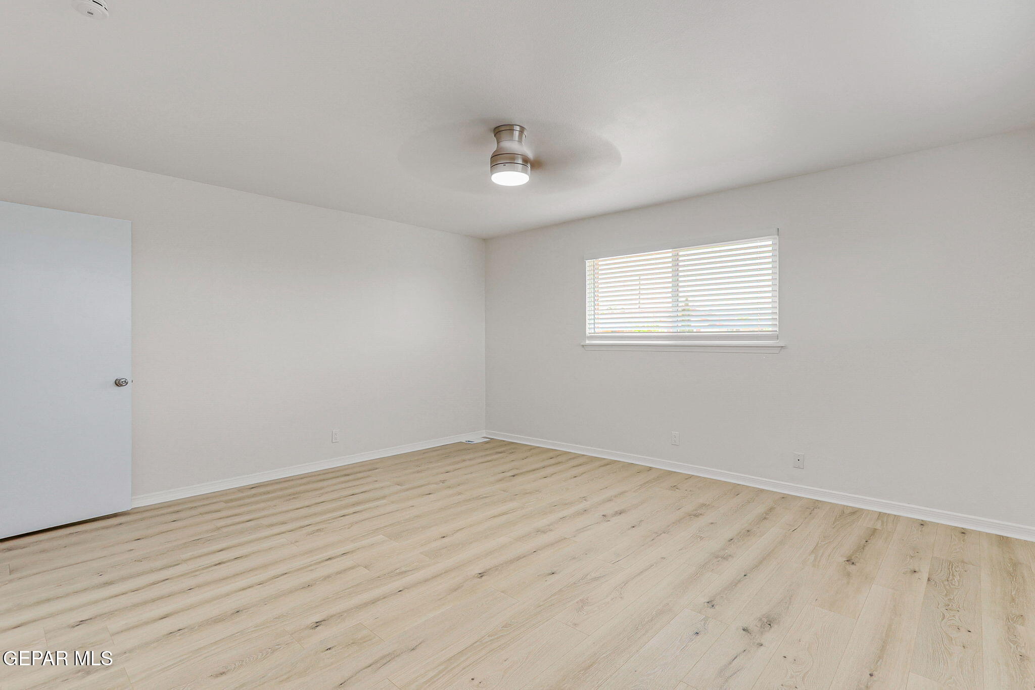 309 Clairemont Road El Paso, TX 79912 - Photo 28 of 40 an empty room with wooden floor and windows