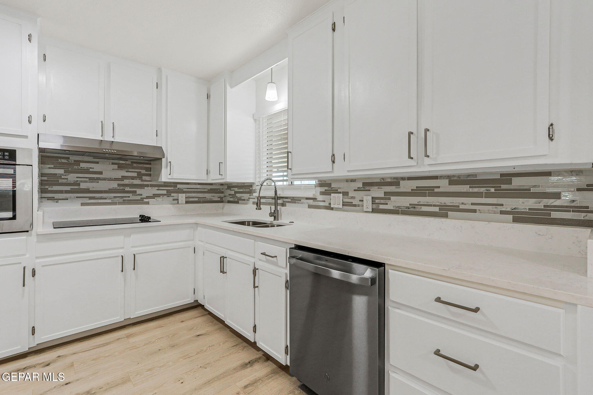 309 Clairemont Road El Paso, TX 79912 - Photo 6 of 40 a kitchen with stainless steel appliances granite countertop white cabinets sink and dishwasher