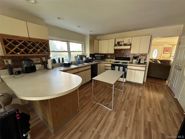 a kitchen with a table chairs stove and cabinets