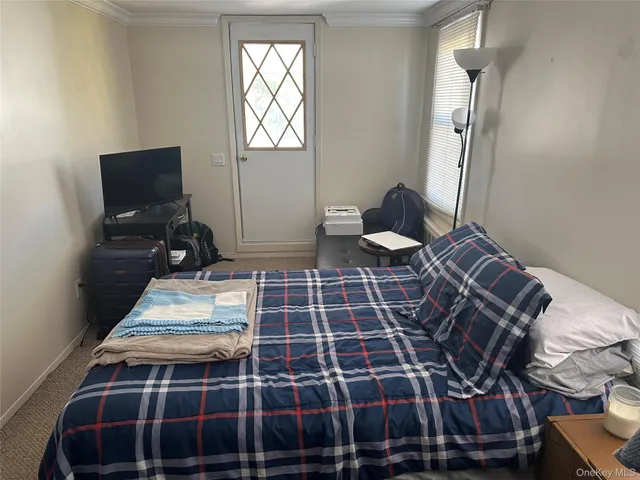 a bedroom with double bed and a window