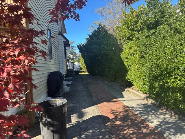 a backyard of a house with table and chairs