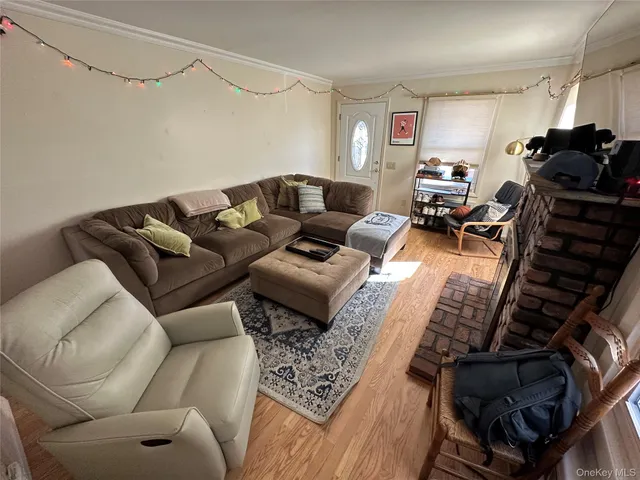 a living room with furniture a couch and a ceiling fan