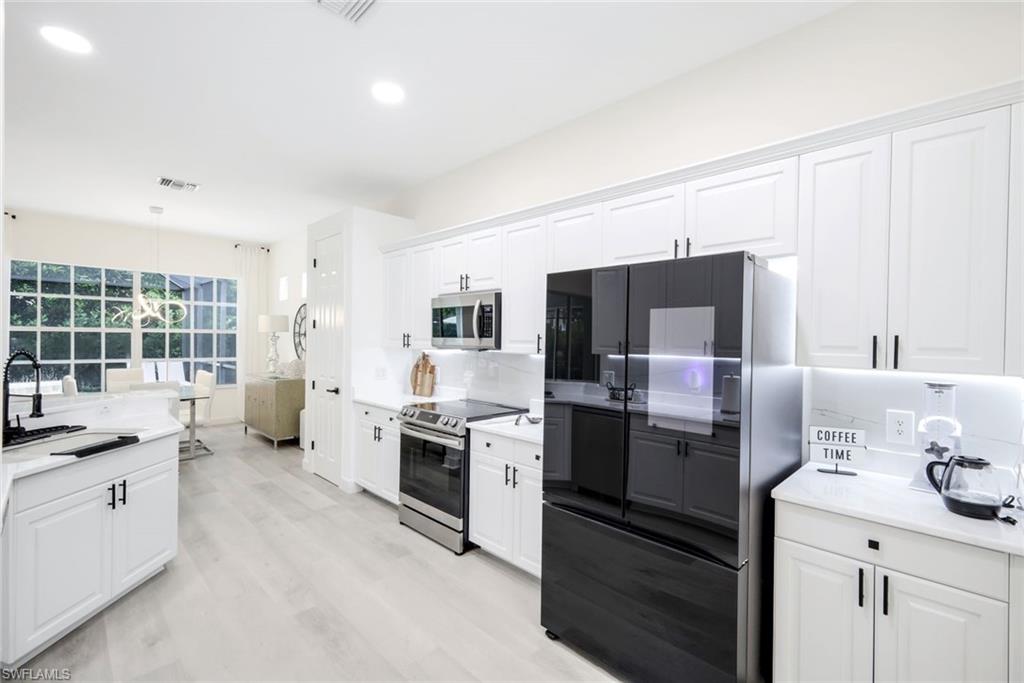 16188 Parque Lane Naples, FL 34110 - Photo 14 of 29 a kitchen with a sink stove and refrigerator