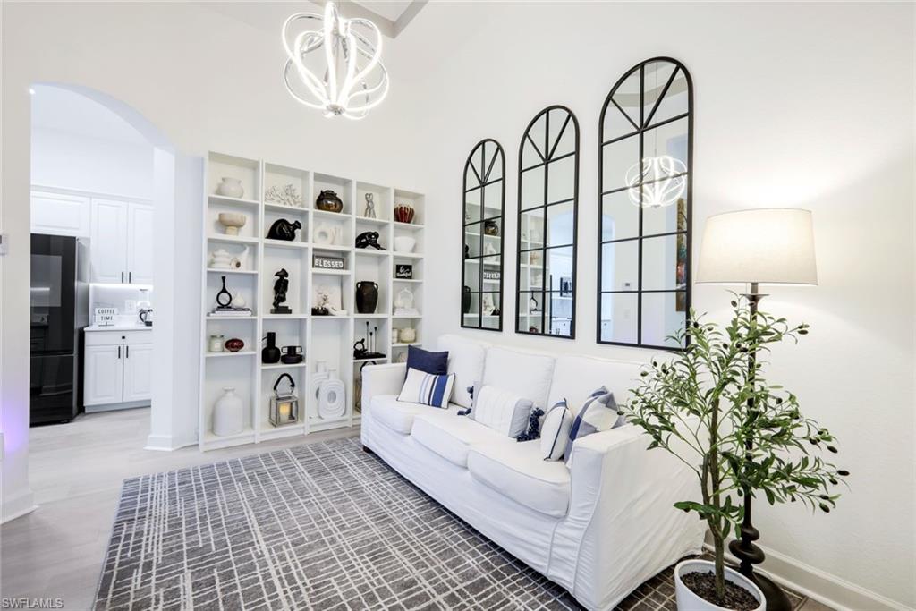 16188 Parque Lane Naples, FL 34110 - Photo 16 of 29 a living room with furniture and a large mirror