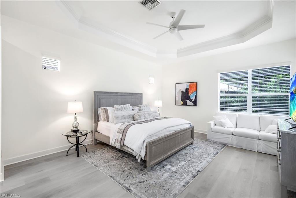 16188 Parque Lane Naples, FL 34110 - Photo 17 of 29 a bedroom with a large bed and a couch