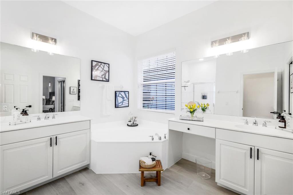 16188 Parque Lane Naples, FL 34110 - Photo 19 of 29 a room with a sink and a lamp on a dresser