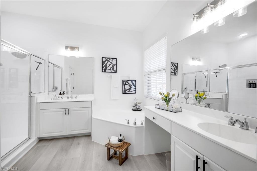 16188 Parque Lane Naples, FL 34110 - Photo 20 of 29 a bathroom with a double vanity sink mirror and bathtub