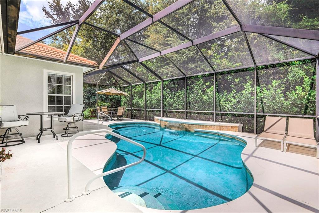 16188 Parque Lane Naples, FL 34110 - Photo 26 of 29 a view of a swimming pool with a patio