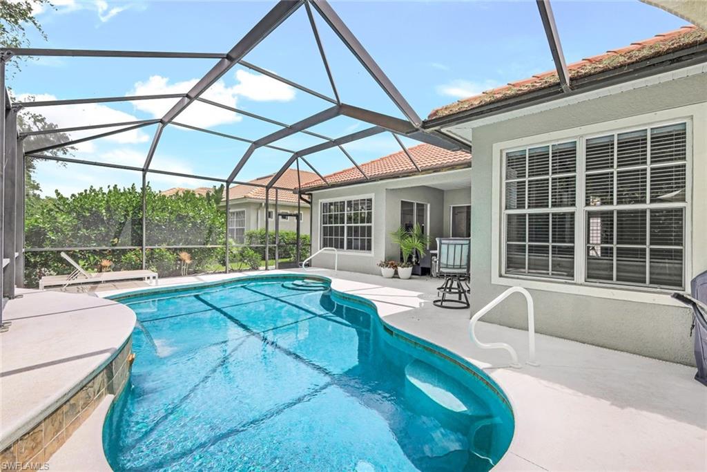 16188 Parque Lane Naples, FL 34110 - Photo 27 of 29 a swimming pool with outdoor seating and yard