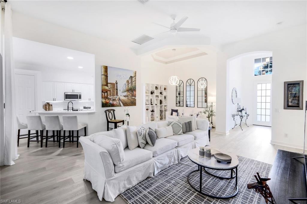16188 Parque Lane Naples, FL 34110 - Photo 5 of 29 a living room with furniture kitchen view and a wooden floor