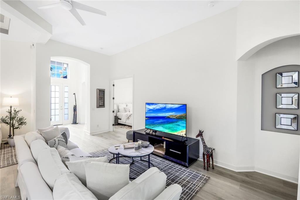 16188 Parque Lane Naples, FL 34110 - Photo 6 of 29 a living room with furniture and a flat screen tv