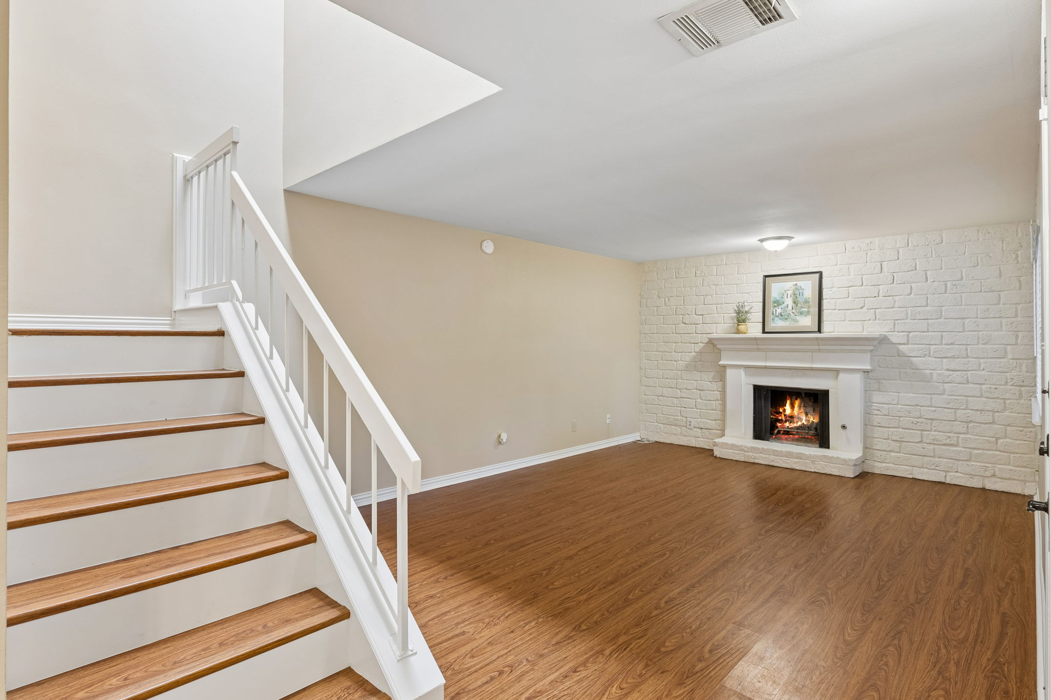 8340 Fathom Circle, Unit 103 Austin, TX 78750 - Photo 7 of 30 a view of an empty room with wooden floor fireplace and a window