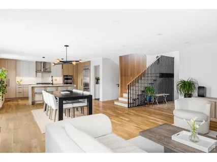 a open dining room with kitchen island furniture a large window and kitchen view