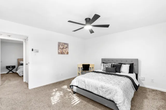 a bedroom with a bed and a window