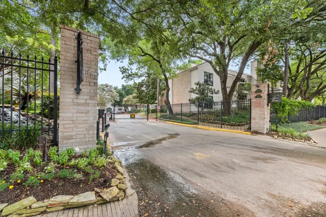 a sign that is sitting in front of flowers