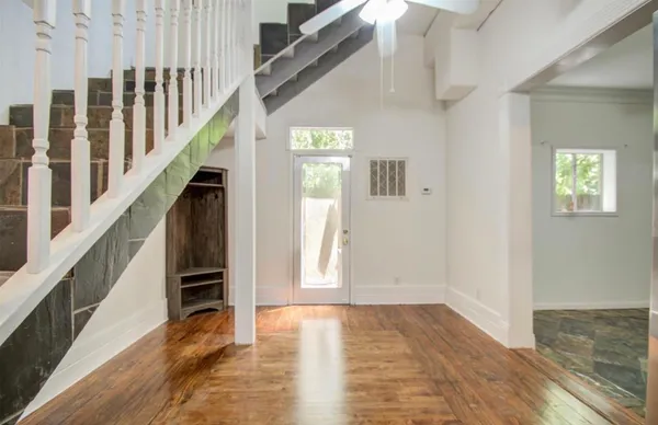 a view of an entryway with wooden floor and stairs