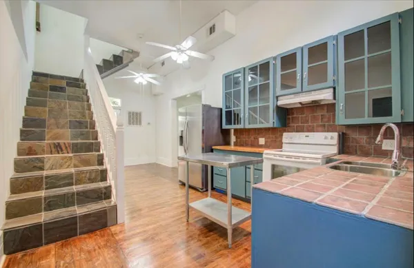 a kitchen with a cabinets and chairs