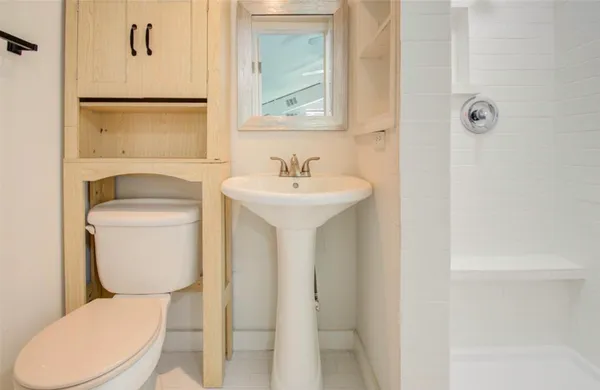 a white toilet sitting next to a bathroom sink