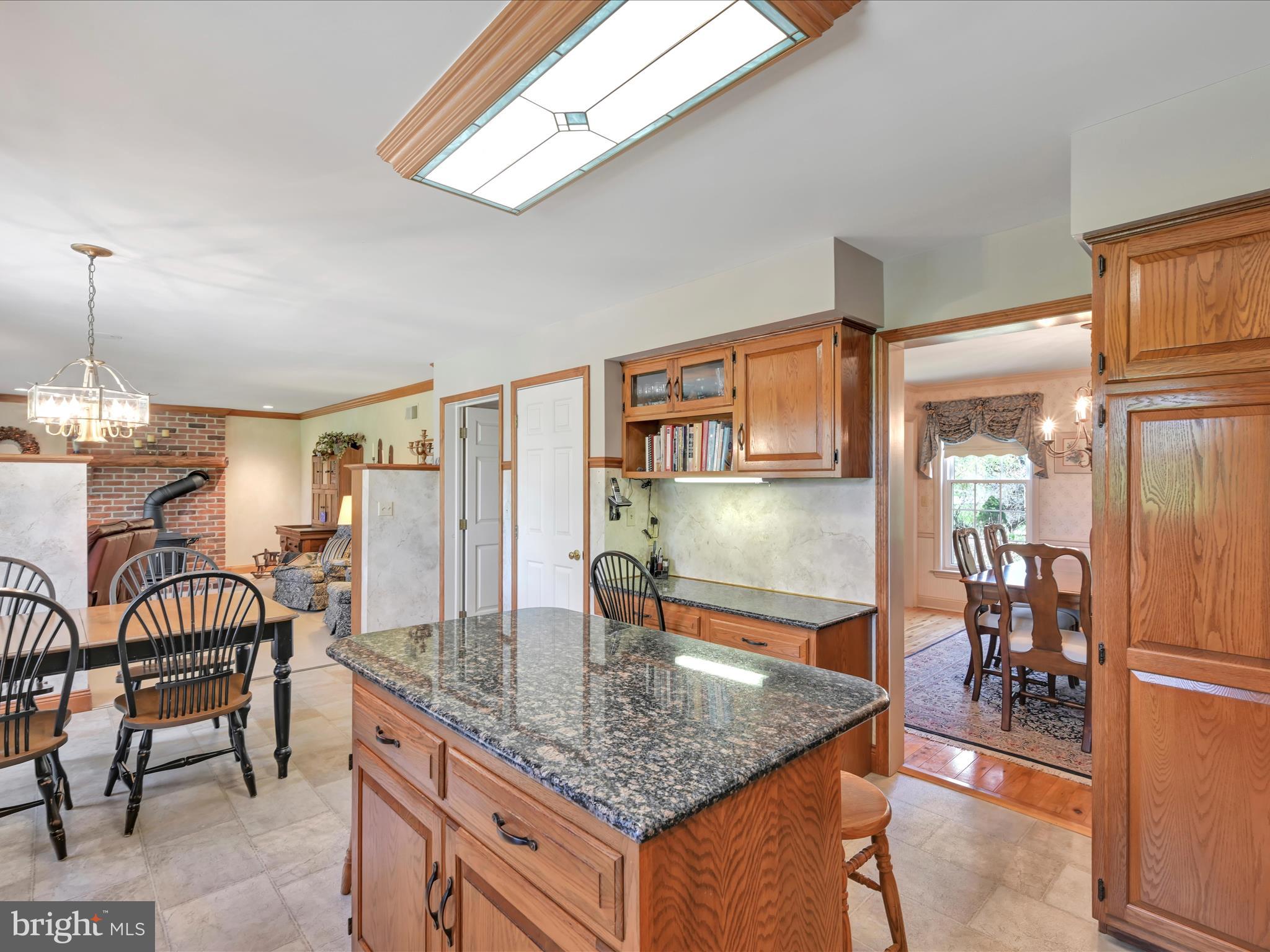 29 Church Road Lancaster, PA 17603 - Photo 15 of 64 a kitchen with stainless steel appliances granite countertop a table chairs and a refrigerator