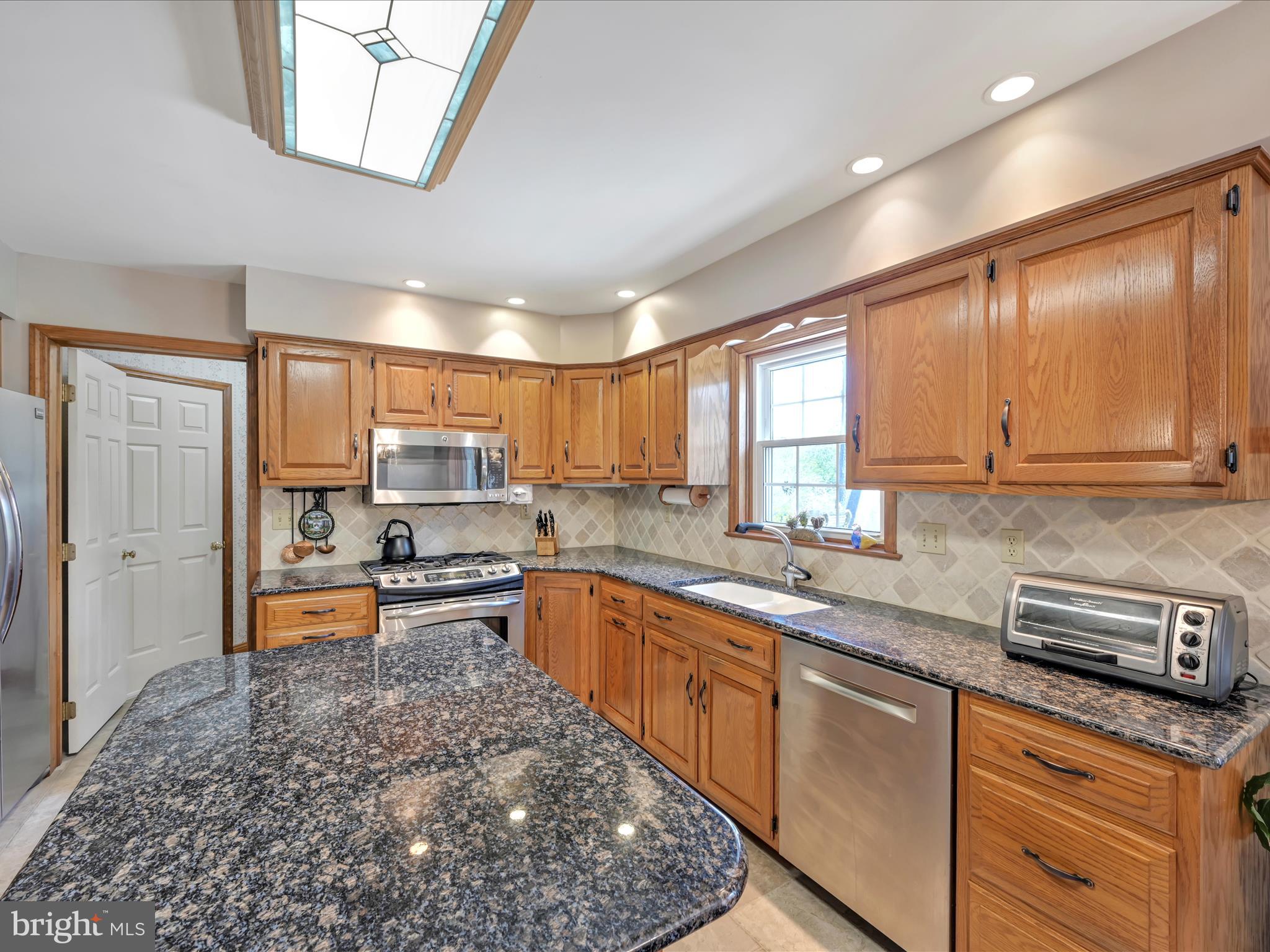 29 Church Road Lancaster, PA 17603 - Photo 16 of 64 a kitchen with stainless steel appliances granite countertop a sink stove and cabinets