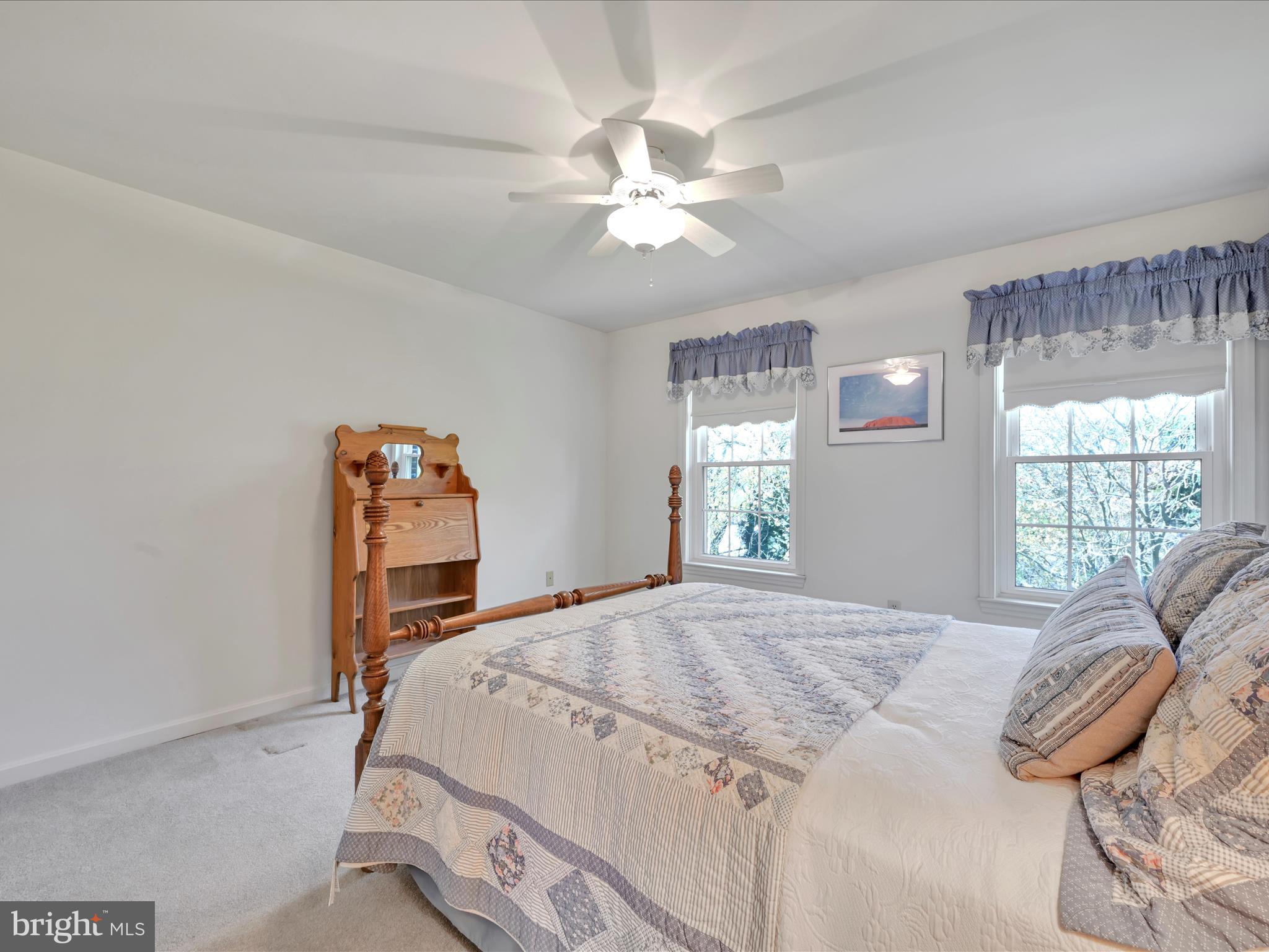 29 Church Road Lancaster, PA 17603 - Photo 28 of 64 a bedroom with a bed and a chandelier